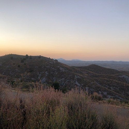 Dusk view of rugged Cabezo de la Jara hills and distant ridges